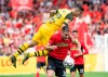 Dortmund's Christian Pulisic, up, and Freiburg's Christian Guenter challenge for the ball during the German Bundesliga soccer match between SC Freiburg and Borussia Dortmund in Freiburg, Germany, Sunday, April 21, 2019. (Patrick Seeger/dpa via AP)