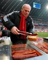 FILE - In this Dec. 19, 2009 file photo, Munich' s President Uli Hoeness grills sausages for supporters prior to the German first division Bundesliga soccer match between FC Bayern Munich and Hertha BSC Berlin in Munich, Germany. Forty years after he first started as general manager, Bayern Munich is celebrating Uli Hoeness for his role in turning it into one of the world's most successful clubs. (AP Photo/Matthias Schrader)