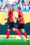 Freiburg's Christian Guenter, left, celebrates with Dominique Heintz, right, after he scores the opening goal during the German Bundesliga soccer match between TSG 1899 Hoffenheim and SC Freiburg in Sinsheim, Germany, Sunday, Sept, 15, 2019. (Uwe Anspach/dpa via AP)