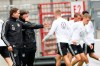 German national soccer team head Joachim Loew, second from left, and assistant coach Marcus Sorg, left, talk together during a training session of the soccer team in Hamburg, Tuesday, Sept. 3, 2019. Germany will play against the Netherland on Friday, Sept. 6, 2019, in a group C qualifier match for the EURO 2020. (Christian Charisius/dpa via AP)