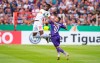 Leipzig's Nordi Mukiele, left, challenges for the ball with Osnabrueck's Anas Quahim, right, during the German soccer cup, DFB Pokal, first Round match between VfL Osnabrueck - RB Leipzig in Osnabrueck, Sunday, Aug. 11, 2019. (Guido Kirchner/dpa via AP)
