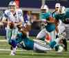 SHARON ELLMAN / THE ASSOCIATED PRESS FILES
Dallas Cowboys quarterback Rudy Carpenter (11) is tackled by Miami Dolphins defensive tackle Kheeston Randall (97) during the second half of a preseason NFL football game in 2012, in Arlington, Texas.