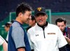 Seattle Mariners starting pitcher Yusei Kikuchi, left, talks with Yomiuri Giants manager Tatsunori Hara prior to their pre-season exhibition baseball game at the Tokyo Dome in Tokyo Sunday, March 17, 2019. (AP Photo/Eugene Hoshiko)