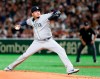 Seattle Mariners starter Felix Hernandez pitches against the Yomiuri Giants in the first inning of their preseason exhibition baseball game at Tokyo Dome in Tokyo, Monday, March 18, 2019. (AP Photo/Toru Takahashi)