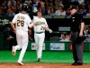 Oakland Athletics' Matt Chapman (26) welcomes Oakland Athletics first baseman Matt Olson (28) scoring on in the fifth inning of Game 2 of the Major League baseball opening series against the Seattle Mariners at Tokyo Dome in Tokyo, Thursday, March 21, 2019. At right is umpire Bill Welke. (AP Photo/Toru Takahashi)