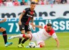 Duesseldorf's Kenan Karaman, right, and Leverkusen's Charles Arangguiz, left, challenge for the ball during the German Bundesliga soccer match between Fortuna Duesseldorf and Bayer 04 Leverkusen in Duesseldorf, Germany, Saturday, Aug. 24, 2019. (Roland Weihrauch/dpa via AP)