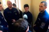 Portuguese Rui Pinto, center, is surrounded by police officers in the hallway of the Metropolitan Court in Budapest, Hungary, Tuesday, March 5, 2019 as he awaits a decision on his extradition to Portugal. (AP Photo/Pablo Gorondi)