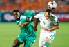 Senegal's Mbaye Hamady Niang, left, and Algeria's Djamel Eddine fight for the ball during the African Cup of Nations final soccer match between Algeria and Senegal in Cairo International stadium in Cairo, Egypt, Friday, July 19, 2019. (AP Photo/Ariel Schalit)