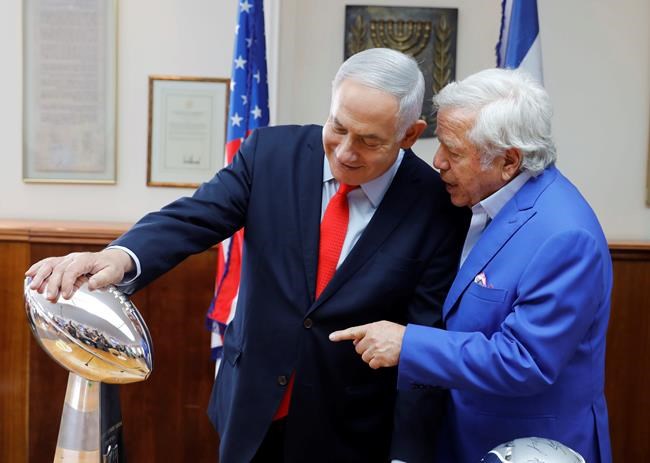 Israel's Prime Minister Benjamin Netanyahu holds the NFL Super Bowl trophy during a meeting with New England Patriots owner Robert Kraft in Jerusalem, Thursday, June 20, 2019. Israel will honor Kraft with the 2019 Genesis Prize for his philanthropy and commitment to combatting anti-Semitism. (AP Photo/Sebastian Scheiner)