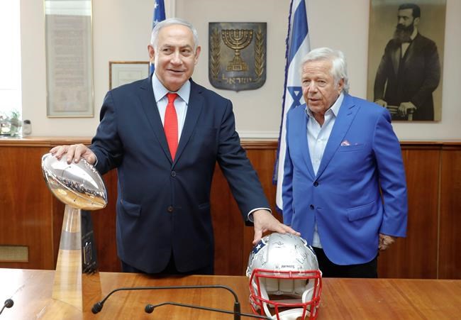 Israel's Prime Minister Benjamin Netanyahu holds the NFL Super Bowl trophy during a meeting with New England Patriots owner Robert Kraft in Jerusalem, Thursday, June 20, 2019. Israel will honor Kraft with the 2019 Genesis Prize for his philanthropy and commitment to combatting anti-Semitism. (AP Photo/Sebastian Scheiner)
