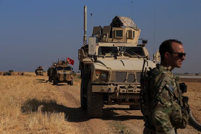 Turkish and American armored vehicles patrol as they conduct joint ground patrol in the so-called