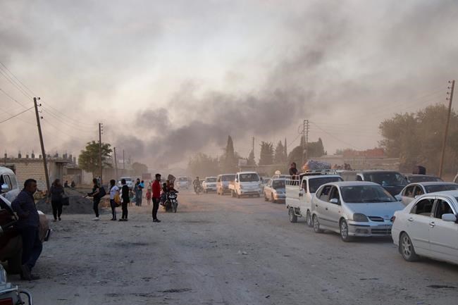 Syrians flee shelling by Turkish forces in Ras al Ayn, northeast Syria, Wednesday, Oct. 9, 2019. Turkish President Recep Tayyip Erdogan announced Wednesday the start of a Turkish military operation against Kurdish fighters in northeastern Syria. (AP Photo)