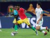 Guinea's Amadou Diawara in action in front of Algeria's Aissa Mandi during the African Cup of Nations round of 16 soccer match between Algeria and Guinea in 30 June stadium in Cairo, Egypt, Sunday, July 7, 2019. (AP Photo/Hassan Ammar)