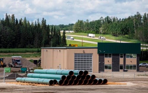 Pipe for the Trans Mountain pipeline is unloaded in Edson, Alta. on Tuesday June 18, 2019. THE CANADIAN PRESS/Jason Franson
