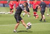 Team Canada's head coach John Herdman kicks a ball during a practice session in Edmonton, Alta., on Friday June 5, 2015. Canada takes on China in their first World Cup match on Saturday June 6, 2015. THE CANADIAN PRESS/Jason Franson