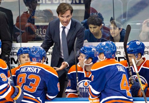 Edmonton Oilers head coach Dallas Eakins talks to his players while playing the New York Rangers during third period NHL pre-season hockey action in Edmonton, Alta., on Tuesday September 24, 2013. THE CANADIAN PRESS/Jason Franson