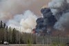A wildfire rage through Fort McMurray Alta, on Wednesday May 4, 2016. The wildfire has already torched 1,600 structures in the evacuated oil hub of Fort McMurray and is poised to renew its attack in another day of scorching heat and strong winds. TTHE CANADIAN PRESS/Jason Franson