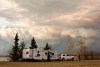 Evacuees camp by a lake as smoke fills the sky near Fort McMurray, Alta., on Wednesday May 4, 2016. The wildfire has already torched 1,600 structures in the evacuated oil hub of Fort McMurray and is poised to renew its attack in another day of scorching heat and strong winds.THE CANADIAN PRESS/Jason Franson