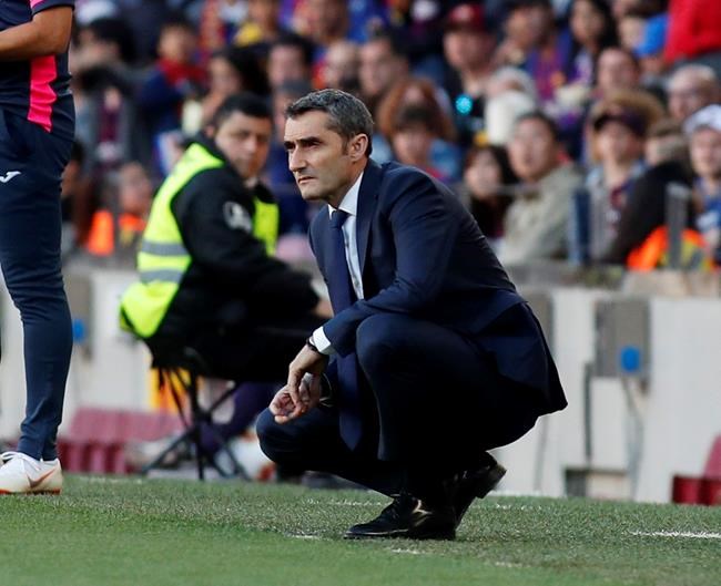 Barcelona coach Ernesto Valverde looks at the game during the Spanish La Liga soccer match between FC Barcelona and Getafe at the Camp Nou stadium in Barcelona, Spain, Sunday, May 12, 2019. (AP Photo)