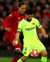 Liverpool's Virgil Van Dijk fights for the ball against Barcelona's Luis Suarez during the Champions League semifinal, second leg, soccer match between Liverpool and FC Barcelona at the Anfield stadium in Liverpool, England, Tuesday, May 7, 2019. (AP Photo/Dave Thompson)