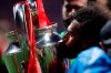 Liverpool's Mohamed Salah kisses the trophy after winning the Champions League final soccer match between Tottenham Hotspur and Liverpool at the Wanda Metropolitano Stadium in Madrid, Saturday, June 1, 2019. (AP Photo/Manu Fernandez)