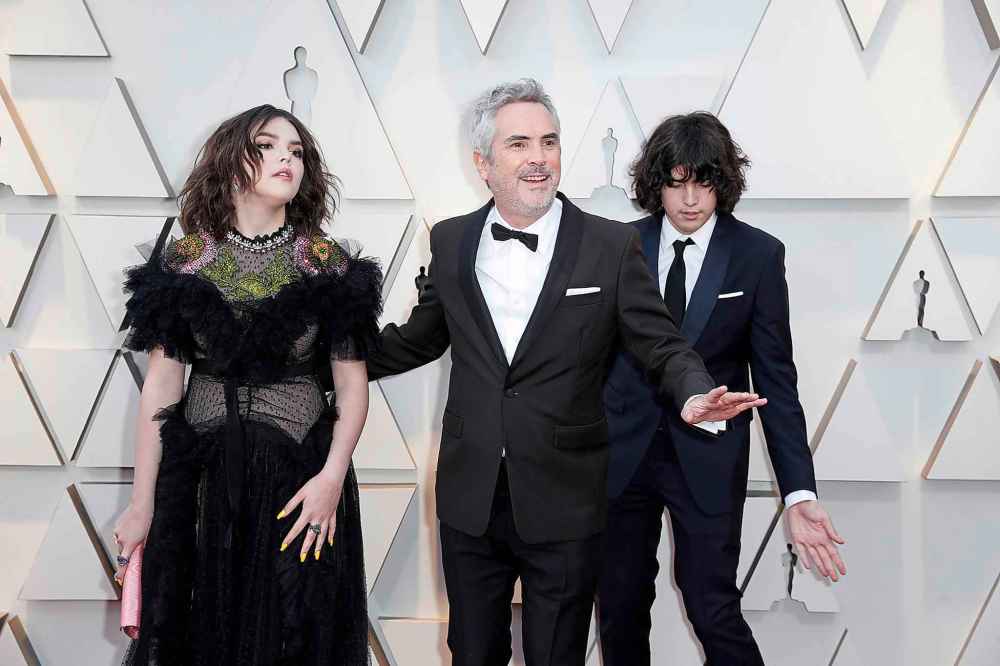 Alfonso Cuaron, middle, with his children Olmo Teodoro Cuaron and Tess Bu Cuaron during before Sunday's ceremonies. (Jay L. Clendenin/Los Angeles Times/TNS)