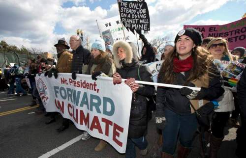 Manuel Balce Ceneta / The Associated Press
From center to right; Bill McKibben, Fiona McRaith, Leah Qusba and Maayan Cohen join a march from the National Mall to the White House in Washington during a rally on calling on President Barack Obama to reject the Keystone XL oil pipeline from Canada, as well as act to limit carbon pollution from power plants and 'move beyond' coal and natural gas, Sunday, Feb. 17, 2013.