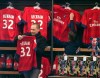 ADDS THE NAME OF THE CLUB A man looks at a soccer shirt on display with the name of British soccer player David Beckham, at the the Paris Saint-Germain club's shop on the Champs Elysees, in Paris, Friday, Feb. 1, 2013. The jersey is on sale for euros 110 ($150). David Beckham lit up a subdued transfer deadline day in Europe by securing perhaps the final move of his globetrotting career, a surprise short-term deal with ambitious French club Paris Saint-Germain. (AP Photo/Michel Euler)