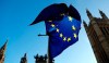 A European flag flies opposite the Houses of Parliament as Pro-European demonstrators protest in London, Monday, Jan. 14, 2019. British Prime Minister Theresa May planned to tell lawmakers Monday that she has received further assurances about her Brexit deal from the European Union, in a last-ditch attempt to stave off a crushing defeat for the unpopular agreement. (AP Photo/Frank Augstein)