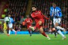 Liverpool's Mohamed Salah shoots on goal during the English Premier League soccer match between Liverpool and Huddersfield Town at Anfield Stadium, in Liverpool, England, Friday, April 26, 2019.(AP Photo/Jon Super)