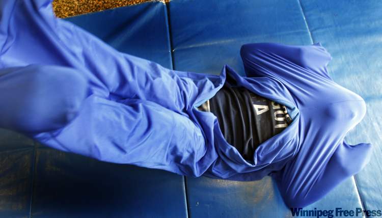 WAYNE.GLOWACKI@FREEPRESS.MB.CA
Stretching inside a body suit helps a Bridges student ‘wake his body up,’ improve his core strength and help with balance.