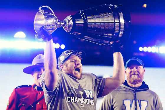 CPWinnipeg Blue Bombers' Jake Thomas lifts the Cup as head coach Mike O'Shea looks on as they celebrate winning the 107th Grey Cup against the Hamilton Tiger Cats in Calgary, Alta., Sunday, November 24, 2019. THE CANADIAN PRESS/Frank Gunn