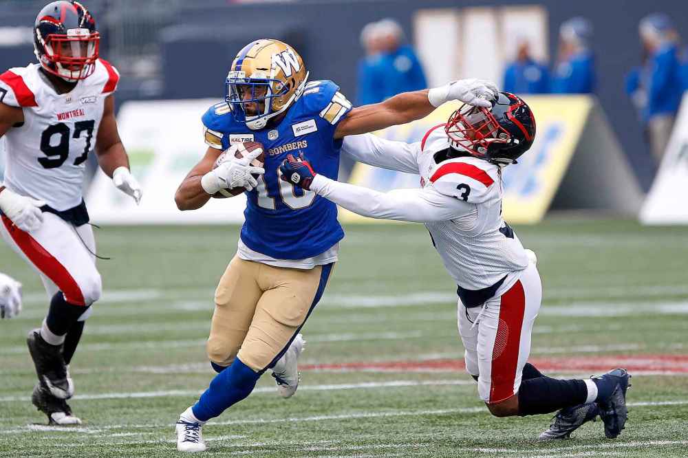 JOHN WOODS / THE CANADIAN PRESS
Winnipeg Blue Bombers' Nic Demski (10) runs for the first down as Montreal Alouettes' Patrick Levels (3) defends during the first half.