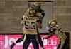 Paul Chiasson / The Canadian Press
Winnipeg Blue Bombers' wide receiver Julian Feoli-Gudino leaps into the arms of teammate Patrick Neufeld after scoring a touchdown against the Montreal Alouettes in the final minutes of the fourth quarter Friday. The Blue Bombers beat the Alouettes 34-33.
