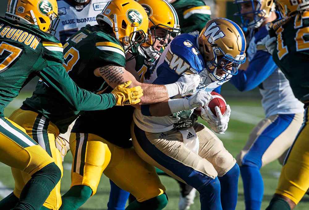 JASON FRANSON / THE CANADIAN PRESS
Winnipeg Blue Bombers Andrew Harris (33) is tackled by the Edmonton Eskimos during first half CFL action in Edmonton, Alta., on Saturday November 3, 2018.