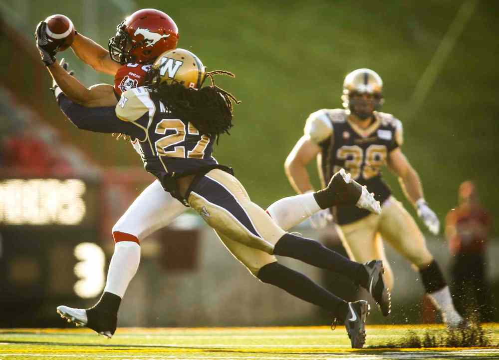 Jeff McIntosh / The Canadian Press
Winnipeg Blue Bombers' Marty Markett, right, covers Calgary Stampeders' Anthony Parker, as he makes a catch during CFL pre-season football action in Calgary on Saturday.