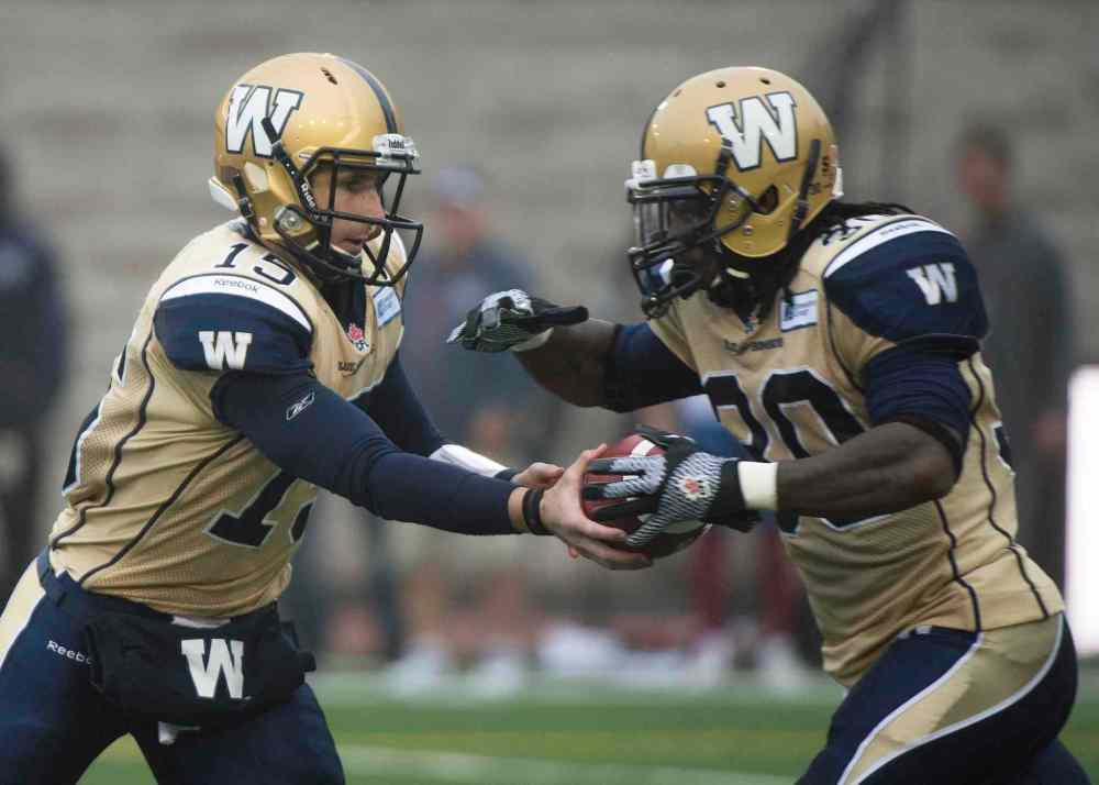 Graham Hughes / THE CANADIAN PRESS
Winnipeg Blue Bombers' quarterback Max Hall, left, hands off to Will Ford during first half CFL football action against the Montreal Alouettes in Montreal, Monda.