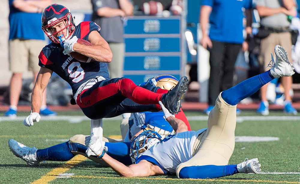CP
GRAHAM HUGHES / THE CANADIAN PRESS
Montreal Alouettes' Jake Wieneke (9) is tackled by Winnipeg Blue Bombers players during first half CFL football action in Montreal, Saturday, Sept. 21, 2019.