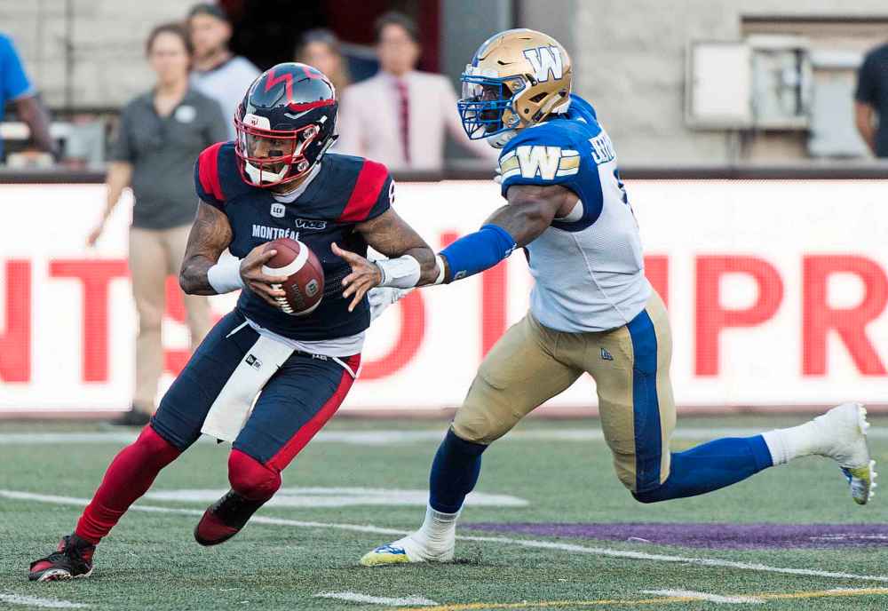 GRAHAM HUGHES / THE CANADIAN PRESS
Montreal Alouettes quarterback Vernon Adams Jr., left, breaks away from Winnipeg Blue Bombers linebacker Adam Bighill during second half CFL football action in Montreal, Saturday, September 21, 2019.