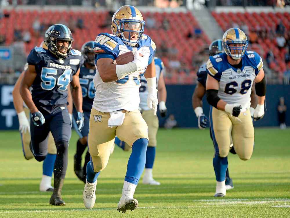 NATHAN DENETTE / THE CANADIAN PRESS
Winnipeg Blue Bombers running back Andrew Harris (33) runs the ball for a touchdown during first half.