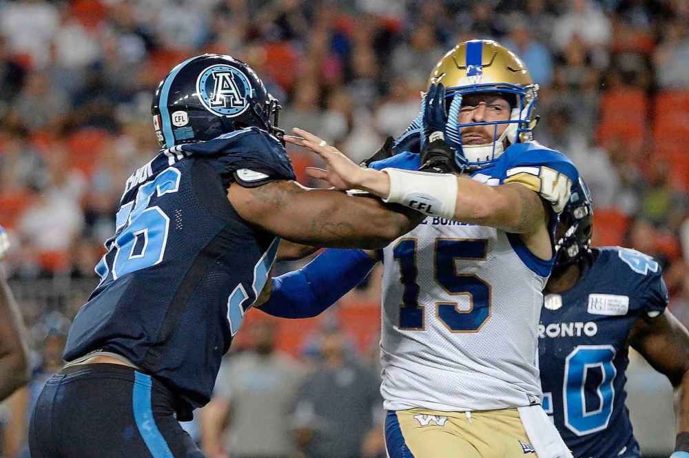 NATHAN DENETTE / THE CANADIAN PRESS
Winnipeg Blue Bombers quarterback Matt Nichols (15) reacts as Toronto Argonauts defensive lineman Freddie Bishop III (56) picks up a penalty for roughing the passer during second half.