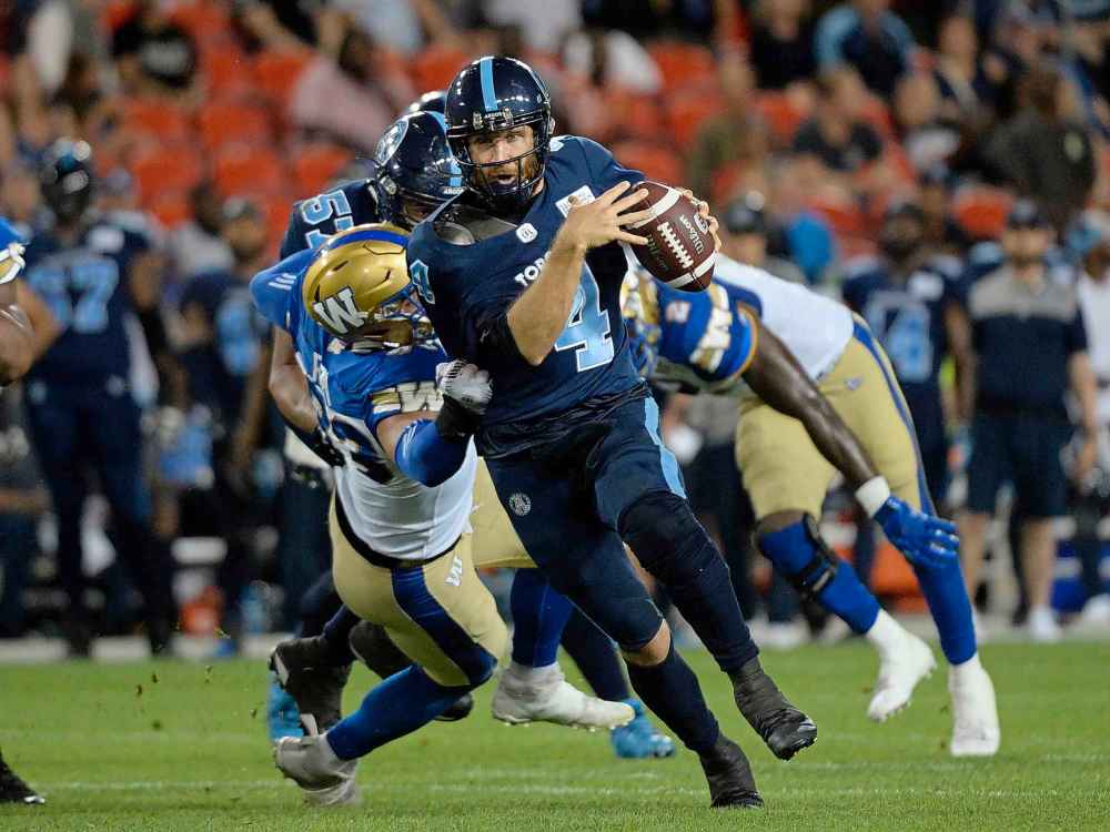 NATHAN DENETTE / THE CANADIAN PRESS
Toronto Argonauts quarterback McLeod Bethel-Thompson (4) runs for the first down against the Winnipeg Blue Bombers during second half CFL football action in Toronto on Thursday, August 1, 2019.