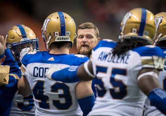 THE CANADIAN PRESSWinnipeg Blue Bombers head coach Mike O'Shea, back, speaks with players before a pre-season CFL football game against the B.C. Lions, in Vancouver, on Friday June 8, 2018. THE CANADIAN PRESS/Darryl Dyck
