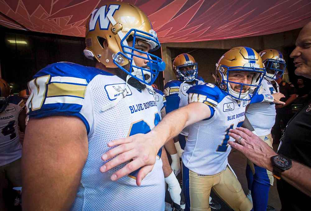 DARRYL DYCK / The Canadian Press
Winnipeg Blue Bombers quarterback Matt Nichols, right, jokingly holds back Sukh Chungh, left, as they wait to take to the field for a CFL football game against the B.C. Lions in Vancouver, on Saturday.
