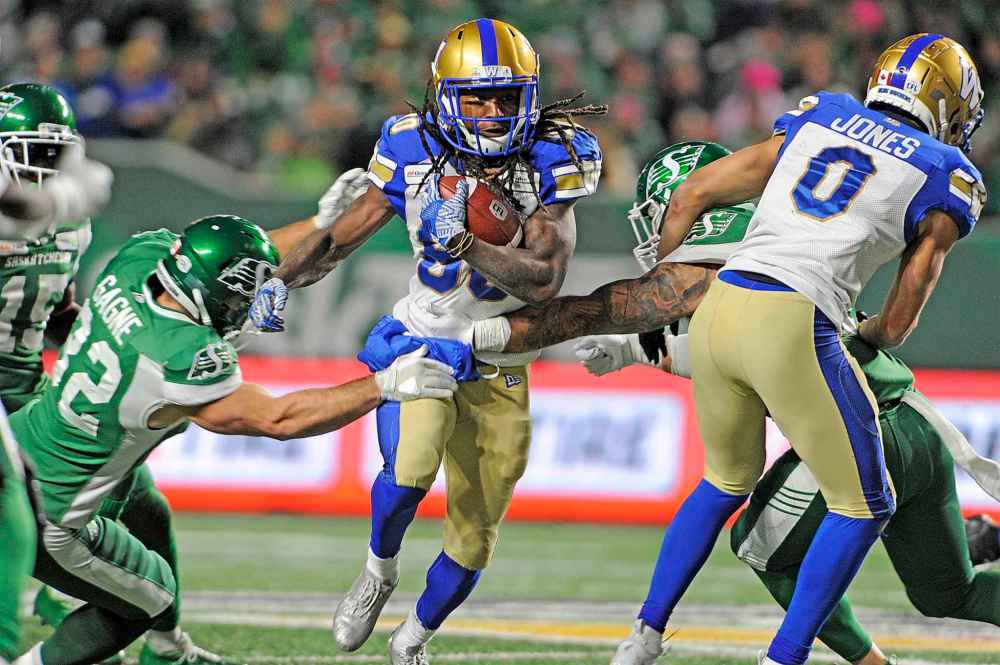 MARK TAYLOR / THE CANADIAN PRESS
Winnipeg Blue Bombers wide receiver Janarion Grant splits a tackle during second half CFL action against the Saskatchewan Roughriders, in Regina on Saturday, Oct. 5, 2019.