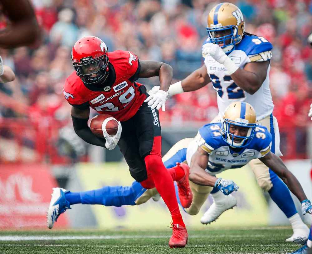 JEFF MCINTOSH / THE CANADIAN PRESS
Winnipeg Blue Bombers' Drake Nevis, top right, and Brandon Alexander, bottom right, look on as Calgary Stampeders' DaVaris Daniels runs the ball in for a touchdown during second quarter CFL football action in Calgary, Saturday, Aug. 25, 2018.