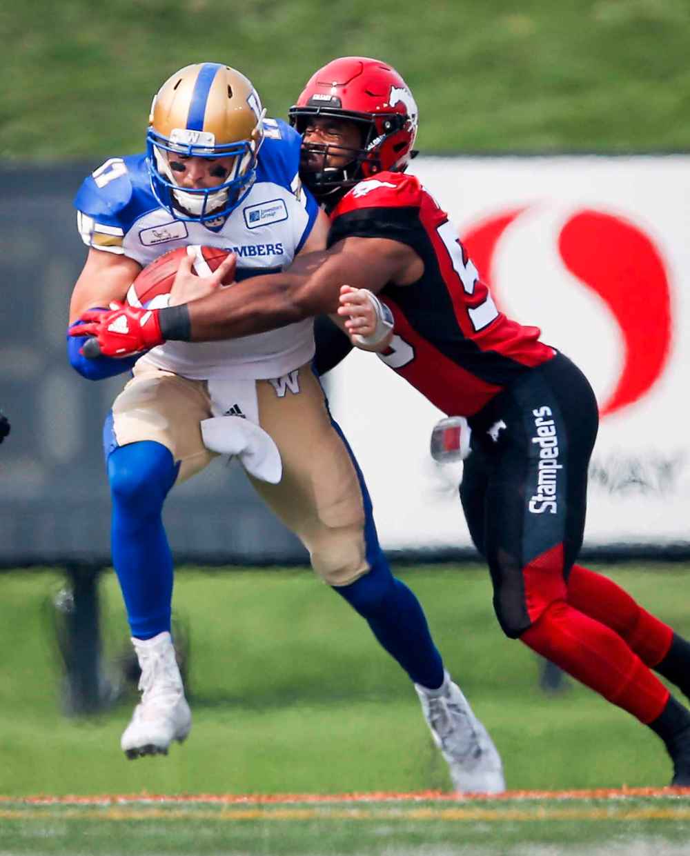 The first Calgary defender on the scene almost always secured the tackle and sealed the deal Saturday, shutting down the Bombers' offence. (Jeff McIntosh / The Canadian Press)