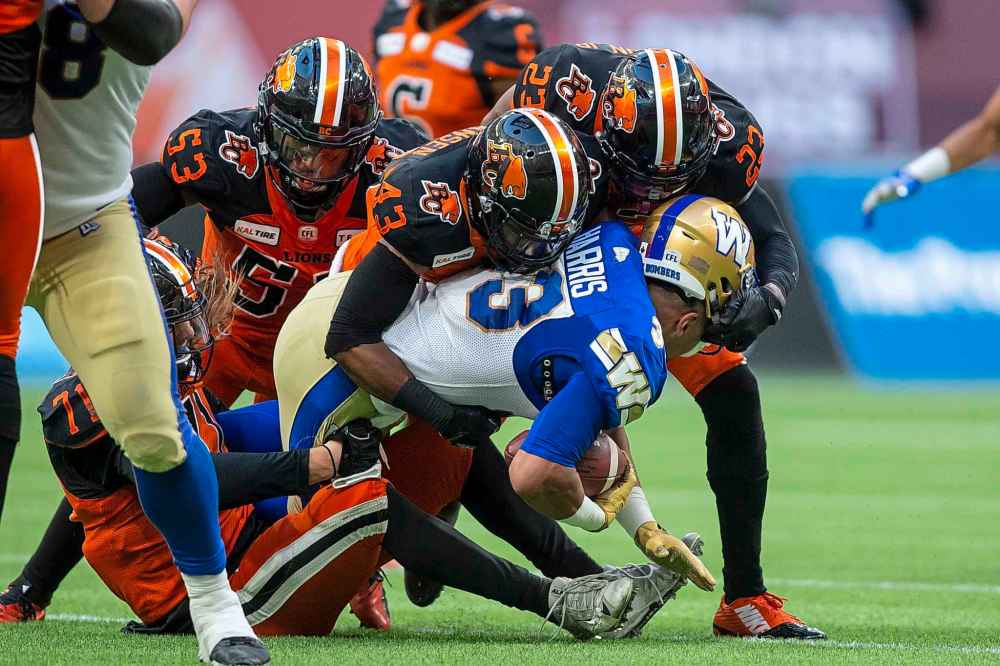 BEN NELMS / THE CANADIAN PRESS
Winnipeg Blue Bombers running back Andrew Harris (33) is tackled by B.C. Lions defensive back Dominique Termansen (43) during the first half.