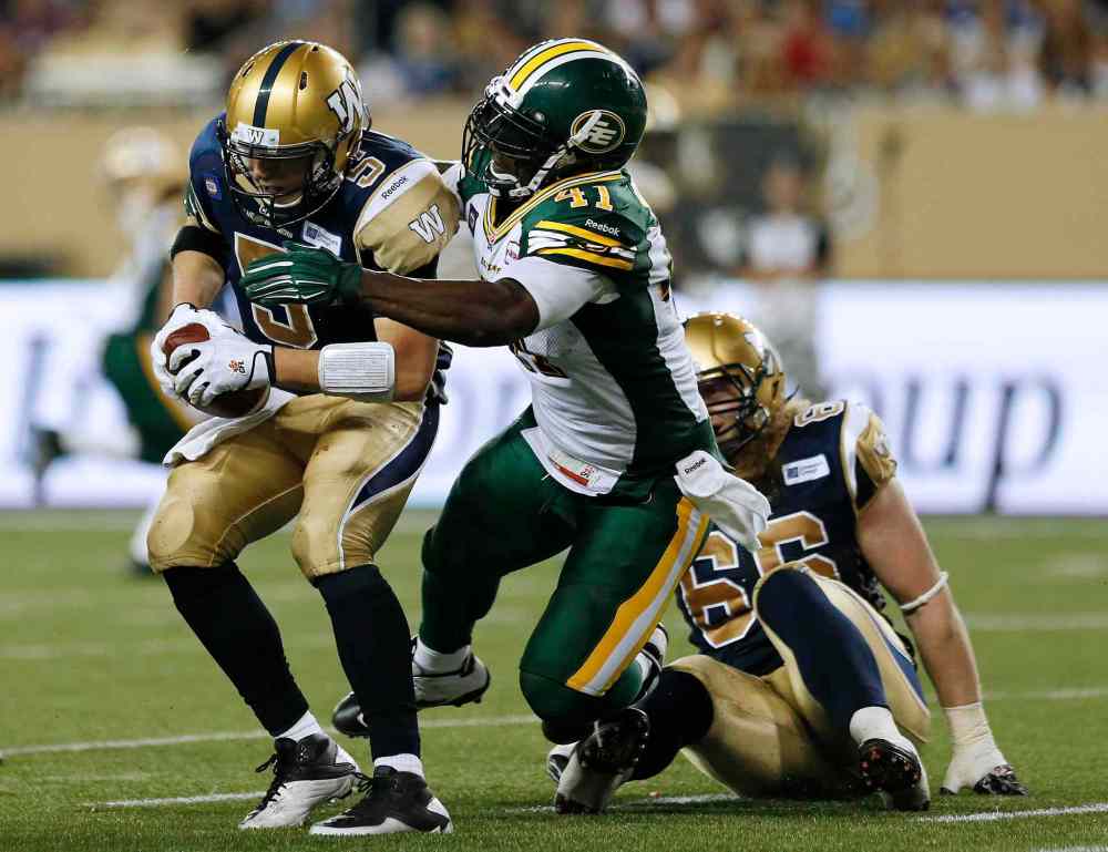 John Woods / THE CANADIAN PRESS
Bombers quarterback Drew Willy was under fire all night from the Edmonton Eskimos defence. Here, he gets hauled down by Odell Willis.