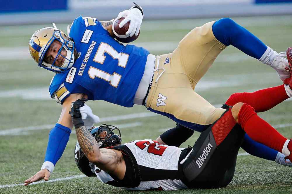 THE CANADIAN PRESS/John Woods
Blue Bombers quarterback Chris Streveler is tackled by Ottawa Redblacks' Anthony Cioffi during the first half in Winnipeg, Friday.
